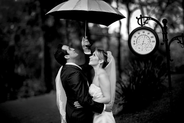 gorgeous bride and groom under umbrella - photo by destination wedding photographer Vinicius Matos
